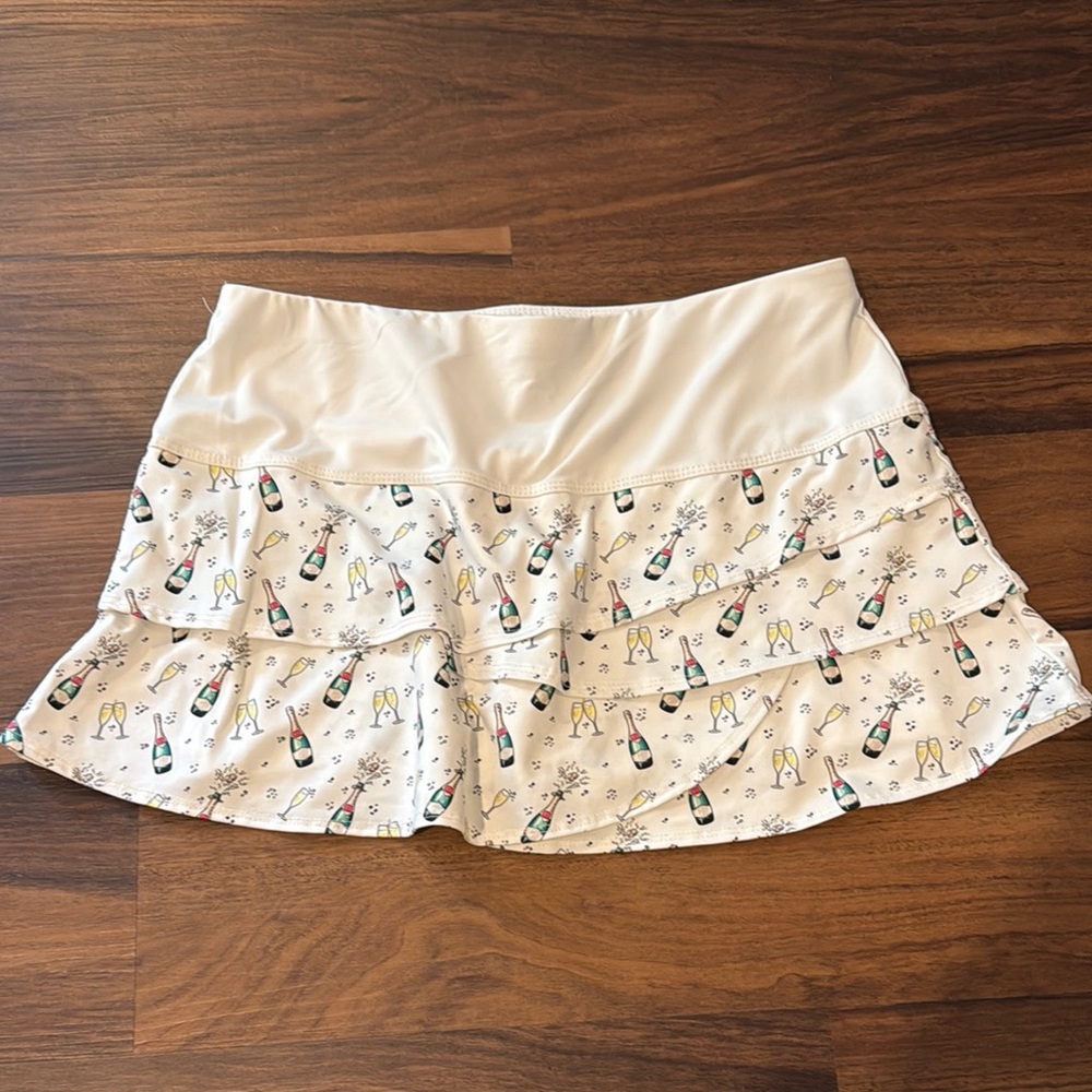Lucky in Love White Ruffle Tennis Skirt with Champagne Motif